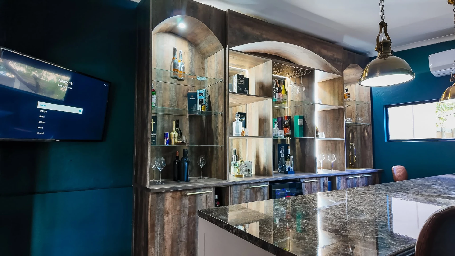 Residents' bar with backlit shelving and marble counter