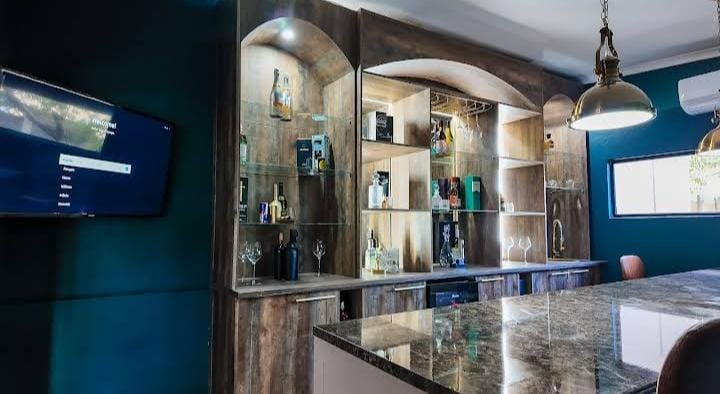 Residents' bar with backlit shelving and stone counter